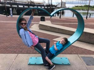 Laura and Jason sitting in a blue heart. Coping as a mom with a disability takes heart.