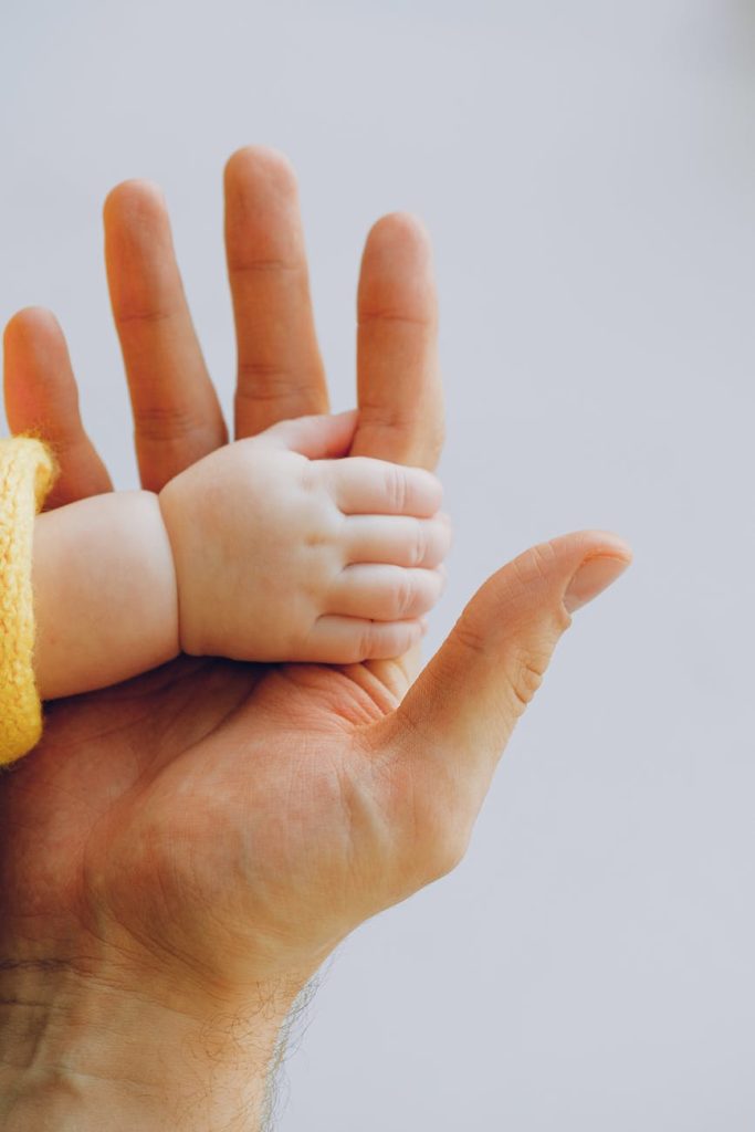 person holding babys hand