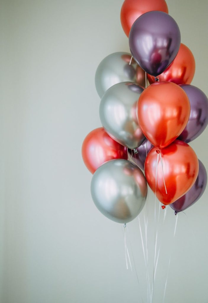 red and white balloons on white wall