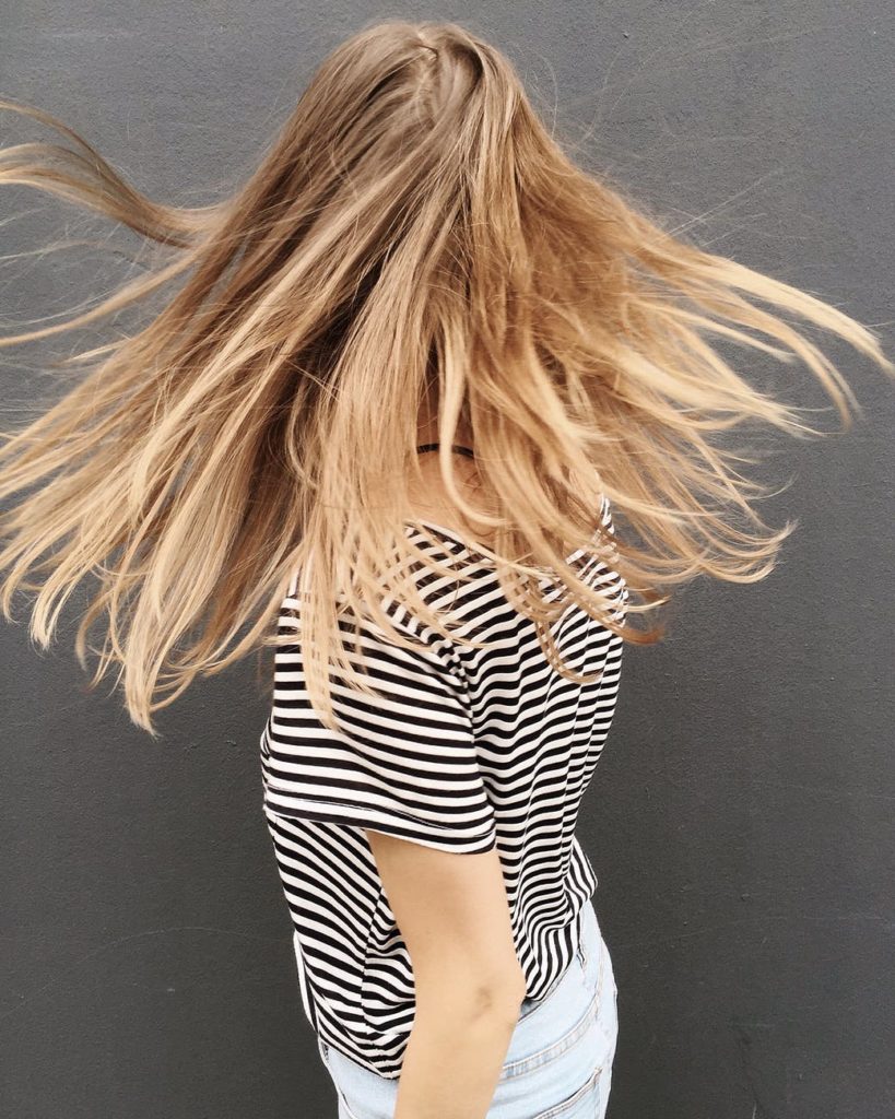 woman wearing black and white stripe blouse