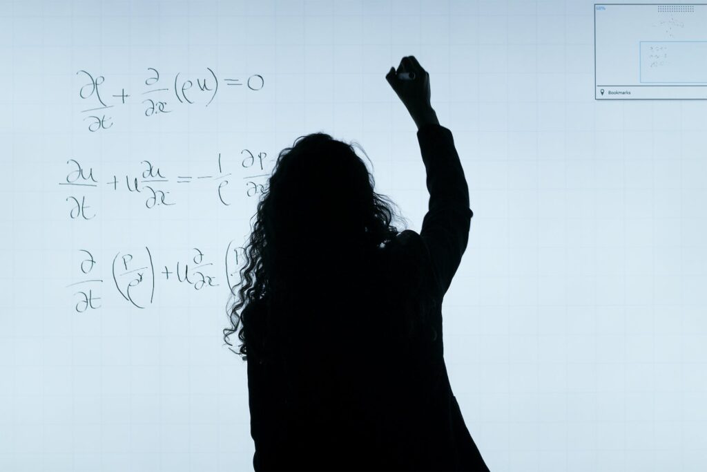 woman writing on a whiteboard