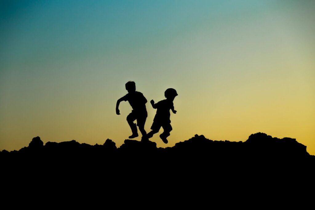 silhouette photo of jumping children